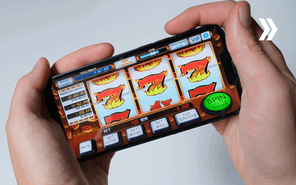 Hands holding smartphone displaying online slot machine game interface